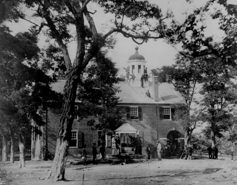 image of men climbing the old fairfax courthouse in black and white